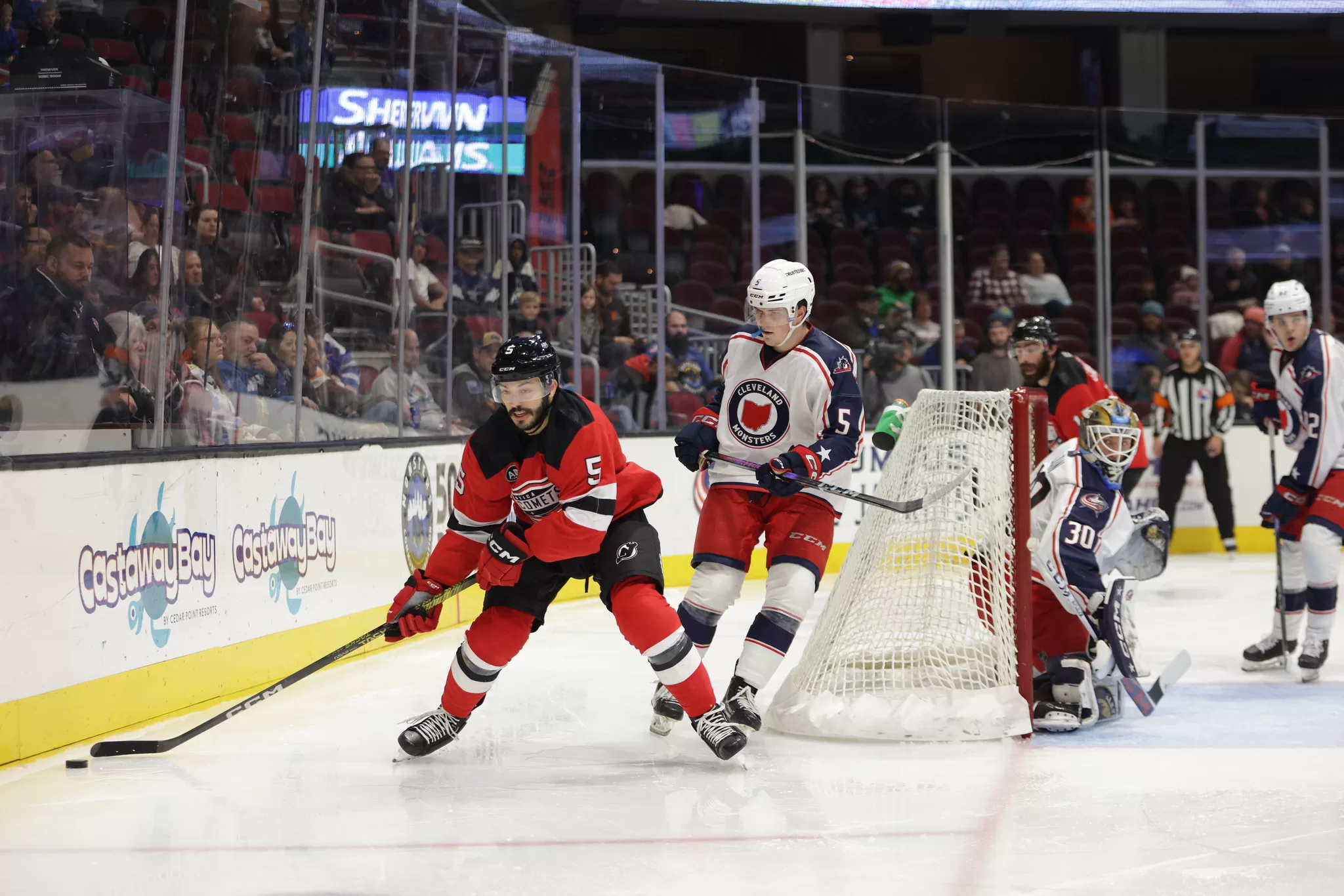 Cleveland Monsters defender Stanislav Svozil pursues Utica Comets defender Robbie Russo behind the Cleveland net on December 3, 2023. Photo credit: Cleveland Monsters