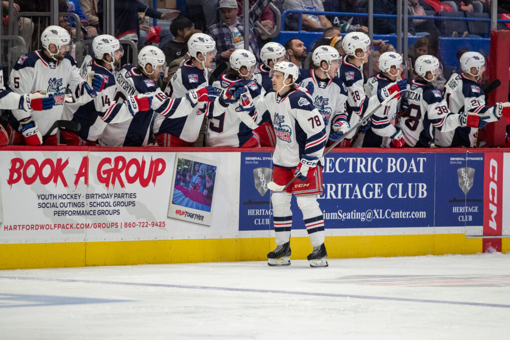 Brennan Othmann celebrates a goal with the Hartford Wolf Pack.