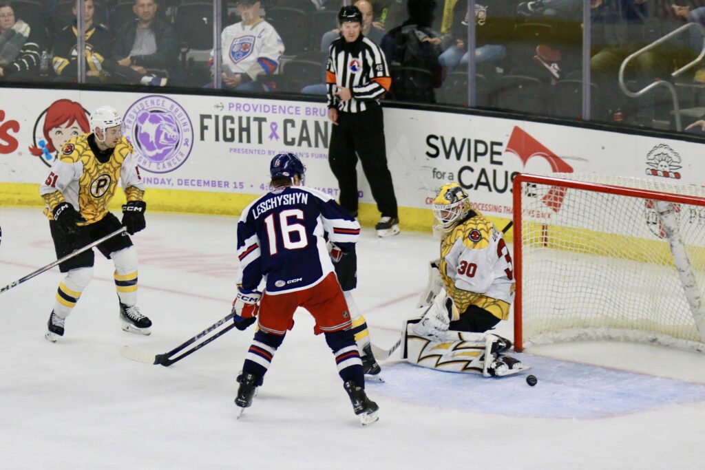 Providence Bruins goaltender Michael DiPietro and defenseman Ian Mitchell defend against Hartford Wolf Pack forward Jake Leschyshyn on November 10, 2024, at Amica Mutual Pavillion in Providence, RI. 
Photo credit: Brian Stone Sr for The Calder Times